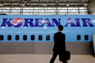 A man walks next to the logo of Korean Air airlines during an organised media tour, at the company's Cabin Crew Training Center in Seoul, South Korea, June 27, 2024.