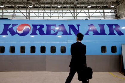 A man walks next to the logo of Korean Air airlines during an organised media tour, at the company's Cabin Crew Training Center in Seoul, South Korea, June 27, 2024.