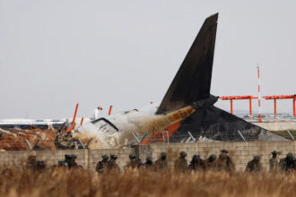 Military personnel respond to the Jeju Air crash at Muan International Airport, inspecting the wreckage.