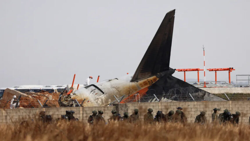 Military personnel respond to the Jeju Air crash at Muan International Airport, inspecting the wreckage.