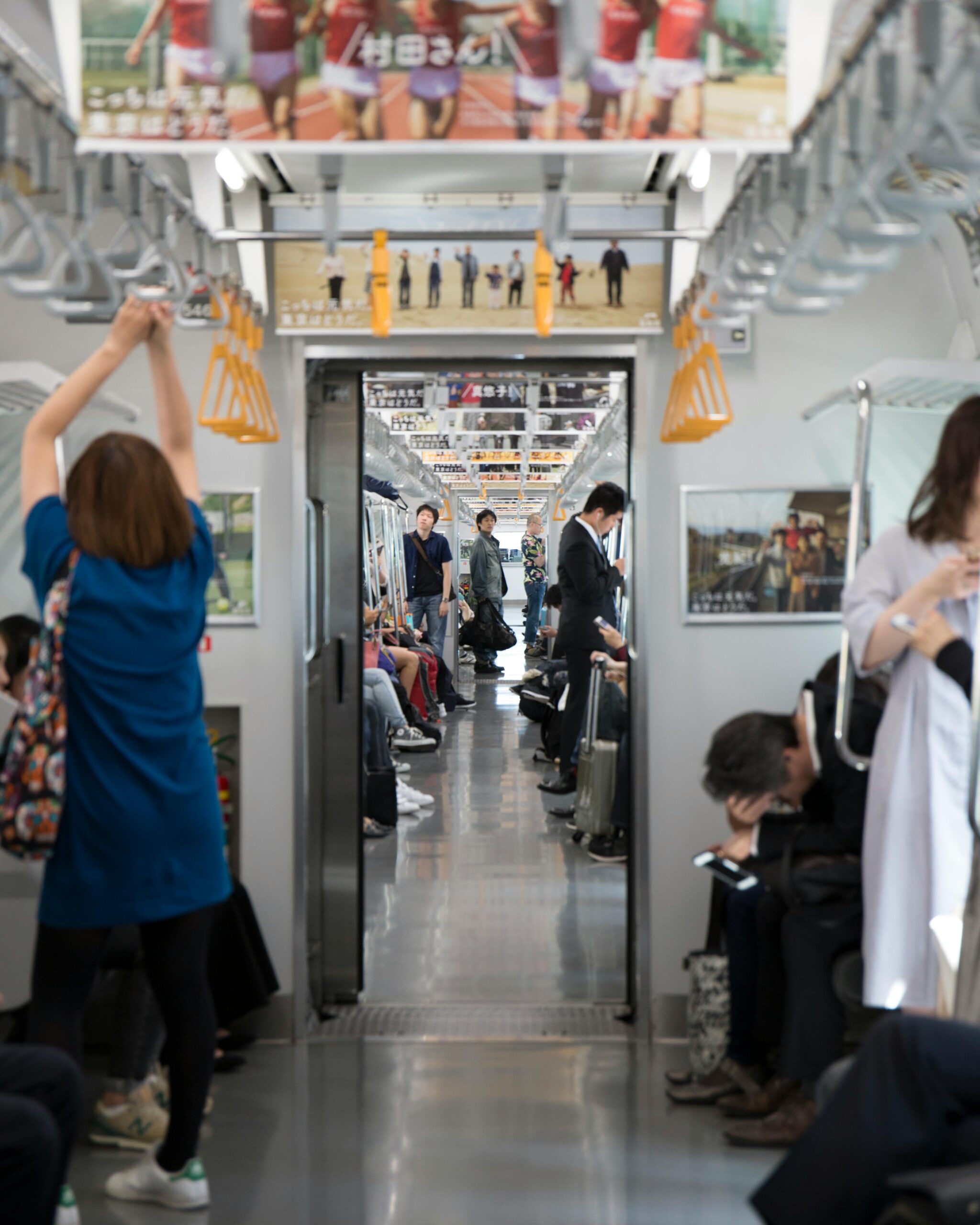 A busy train in Tokyo filled with commuters.