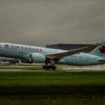 White Air Canada Plane on Green Grass
