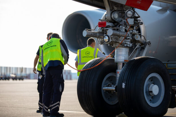 Image of ground staff next to plane wheels wearing hi-vis jackets with Lufthansa logo.