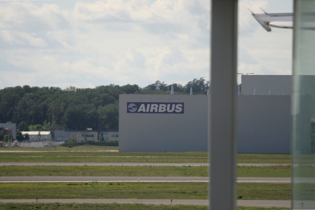 Airbus logo on a hangar on the other side of the Toulouse Blagnac airport.