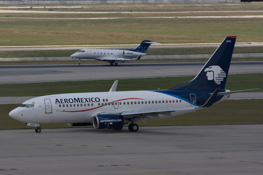 Aeromexico airplane in flight, recognized as the most on-time global airline in Cirium's 2024 rankings.