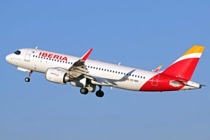 An Iberia Airlines plane flying with landing gear on