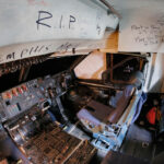 C-5 Galaxy cockpit with farewell messages at an aircraft boneyard.