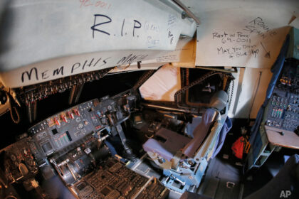 C-5 Galaxy cockpit with farewell messages at an aircraft boneyard.