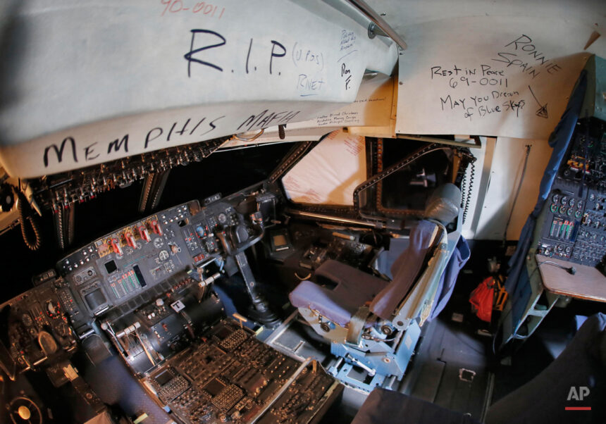 C-5 Galaxy cockpit with farewell messages at an aircraft boneyard.