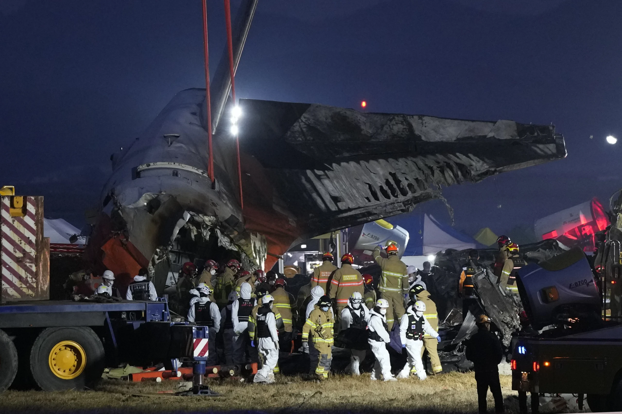 Rescue team carrying the body of a passenger at the site of a plane fire at Muan International Airport, South Korea.