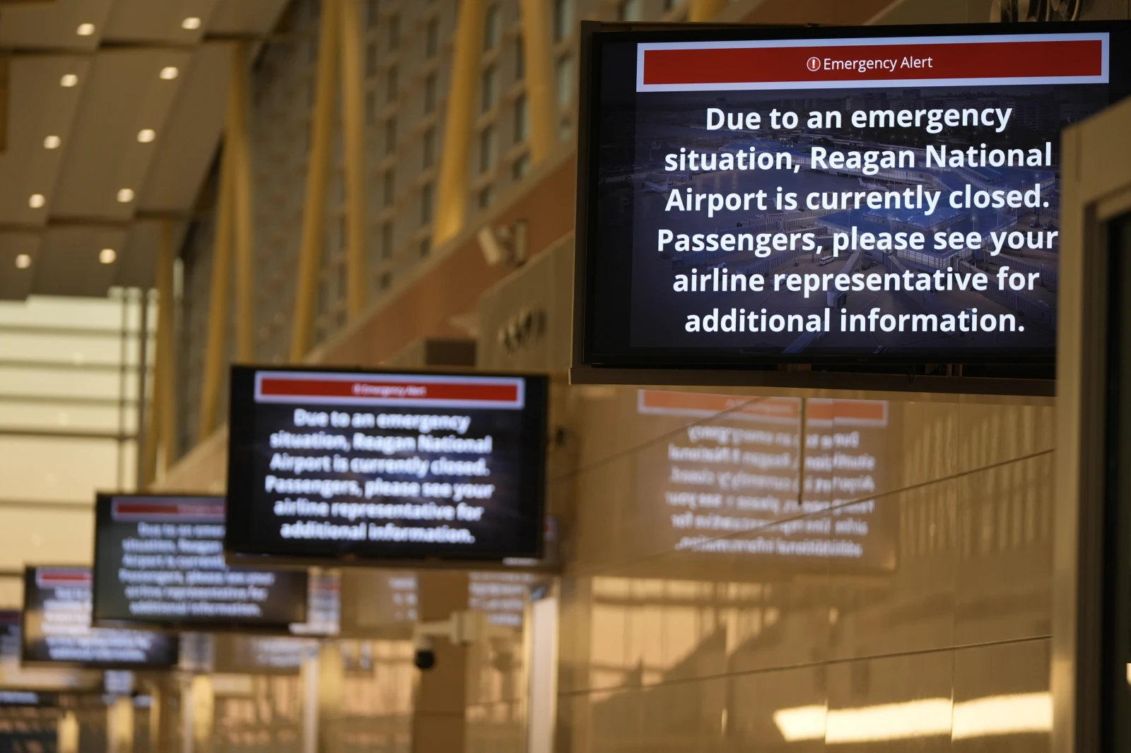 Emergency alert signs displayed at Ronald Reagan Washington National Airport on Jan. 30, 2025.