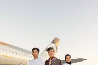 Image of Etihad staff with badminton players in front of etihad aircraft