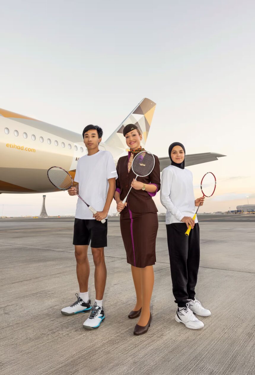 Image of Etihad staff with badminton players in front of etihad aircraft