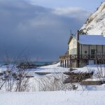 A cottage on the edge of a frozen lake in Hokkaido, Japan.