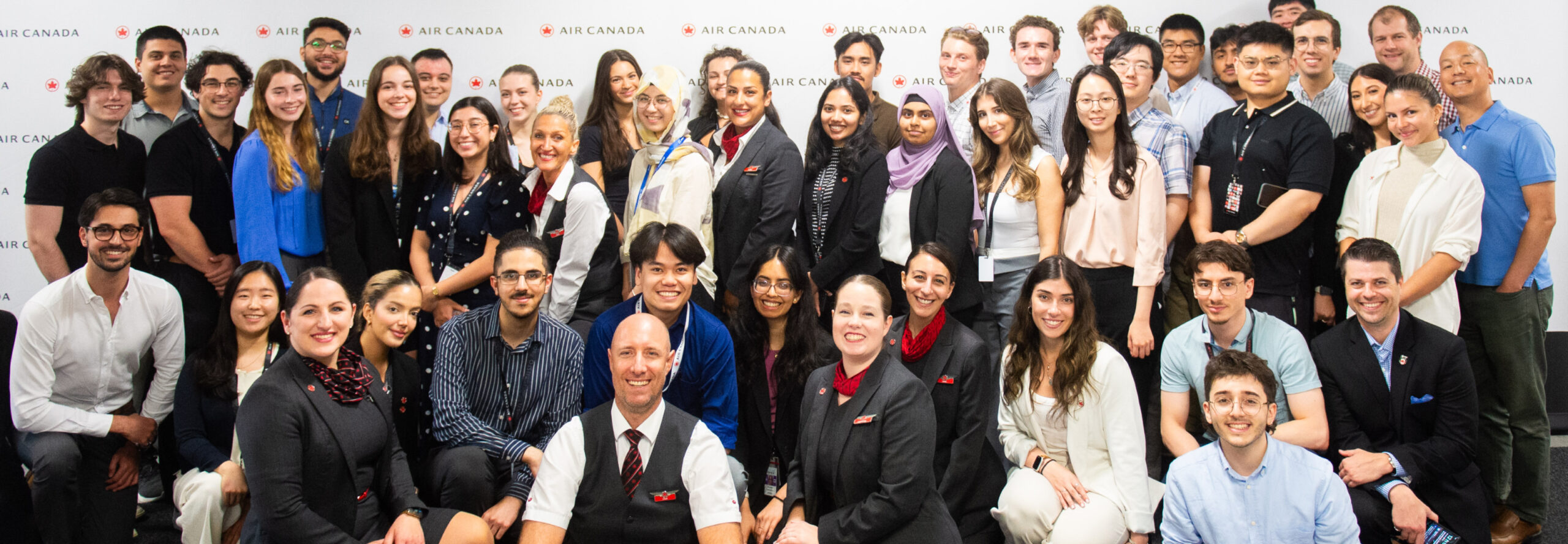 image of young people taking a press photo for air canada