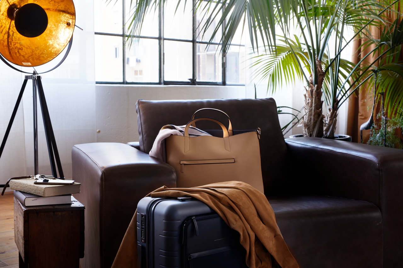 luggage, bag and coat on the leather sofa 