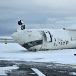 A rear image of an upside-down delta plane in a snowy weather.