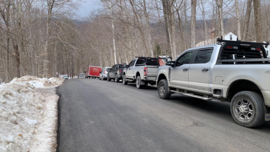 Emergency crews gather at the base of the toll road on Mount Equinox following a small plane crash.