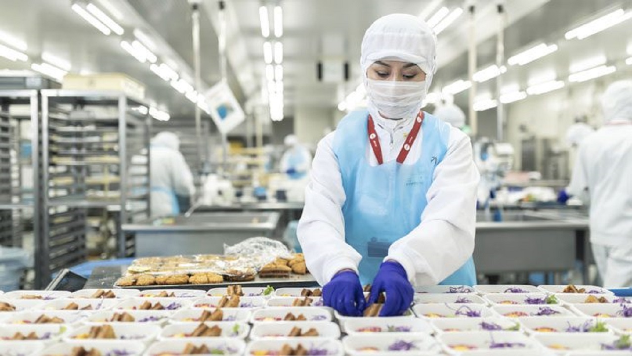 A manufacturer preparing meals for a flight
