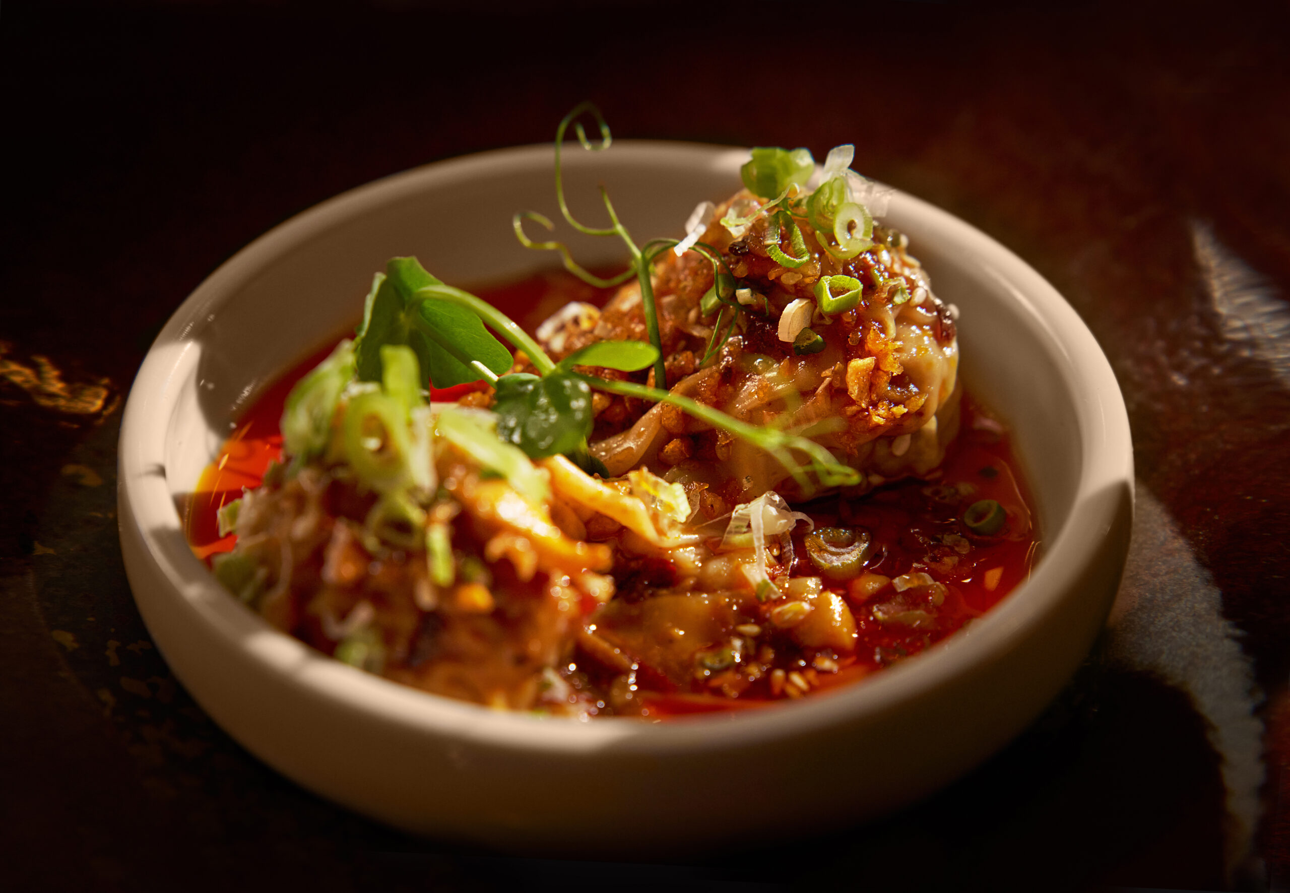 Hand-wrapped Sichuan pork dumplings with chilli sauce