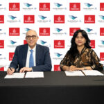 Partnership signing at Aviation Festival Asia 2025 by Dr. Nejib Ben Khedher, Divisional Senior Vice President Emirates Skywards, and Rahmaniar, Miles & Ancillary Group Head Garuda Indonesia.