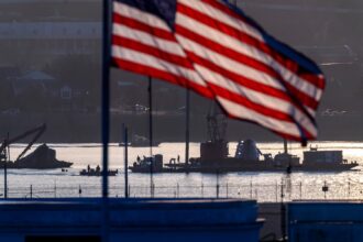 Salvage crews work near the wreckage site in the Potomac River of a mid-air collision between an American Airlines jet and a Black Hawk helicopter