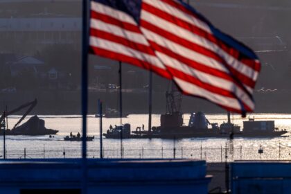 Salvage crews work near the wreckage site in the Potomac River of a mid-air collision between an American Airlines jet and a Black Hawk helicopter