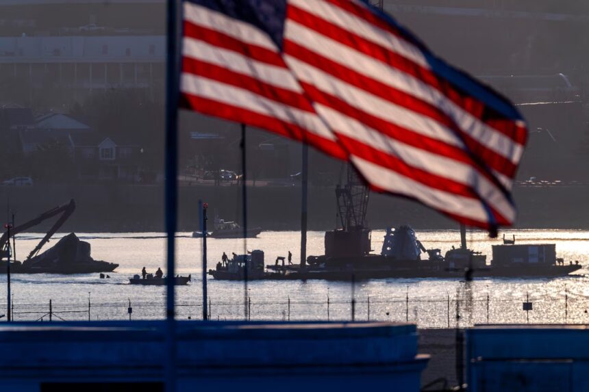 Salvage crews work near the wreckage site in the Potomac River of a mid-air collision between an American Airlines jet and a Black Hawk helicopter