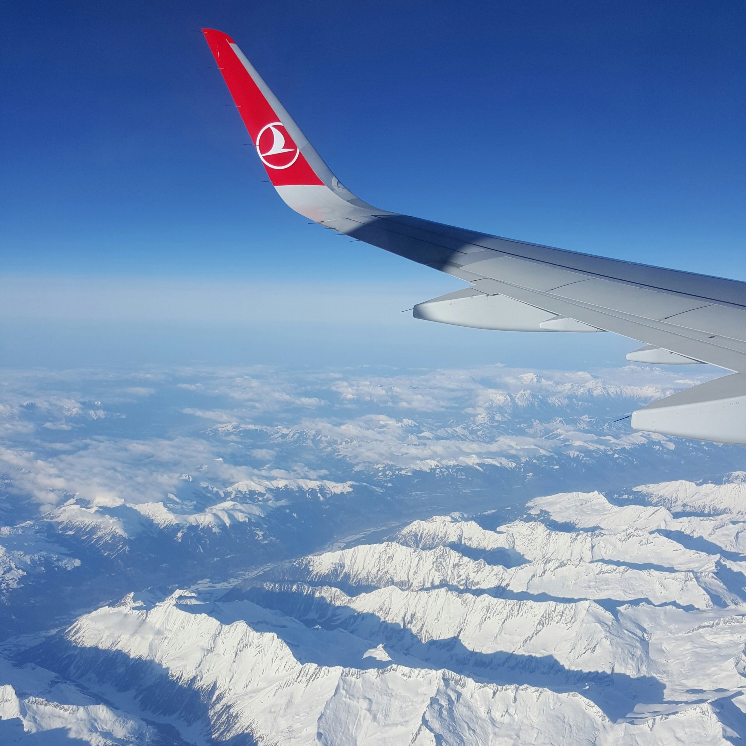 View from the plane over France snow-covered mountains 