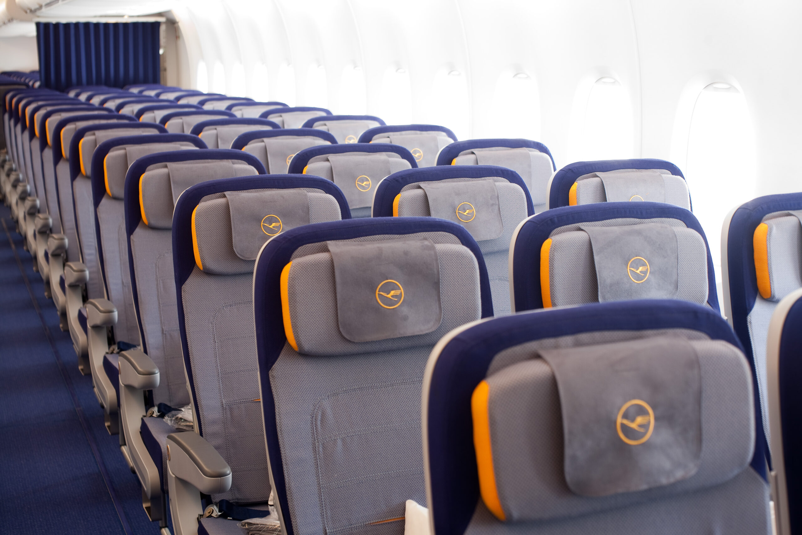 A picture of rows of seats onboard a Lufthansa Group airlines aircraft.