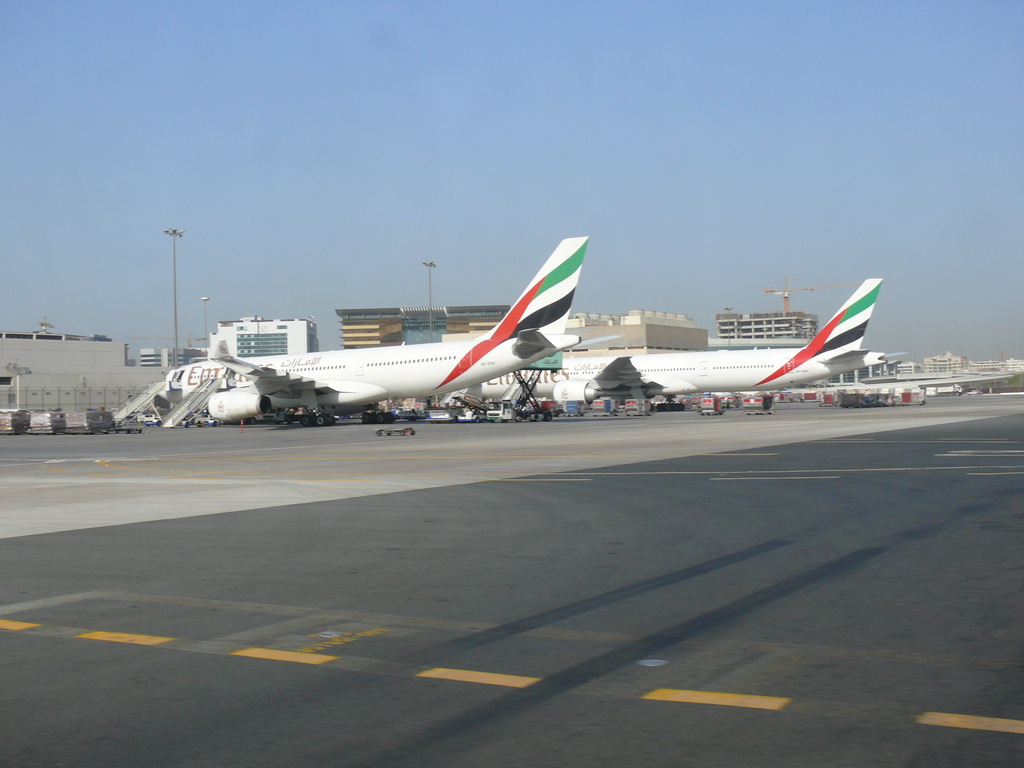  two Emirates Airline planes next to the Dubai Air Cargo Terminal at Dubai International Airport in Dubai, United Arab Emirates 