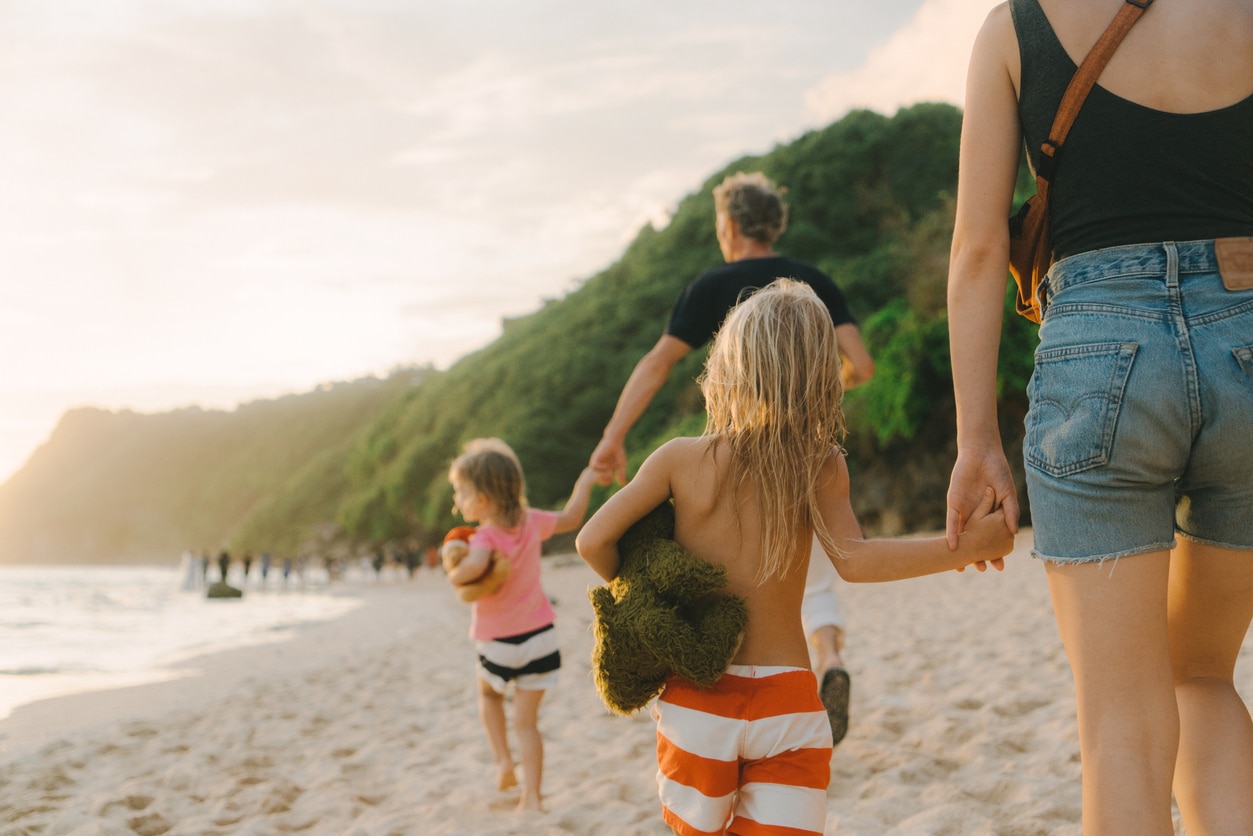 Family walking on the beach in Bali © Mookiland