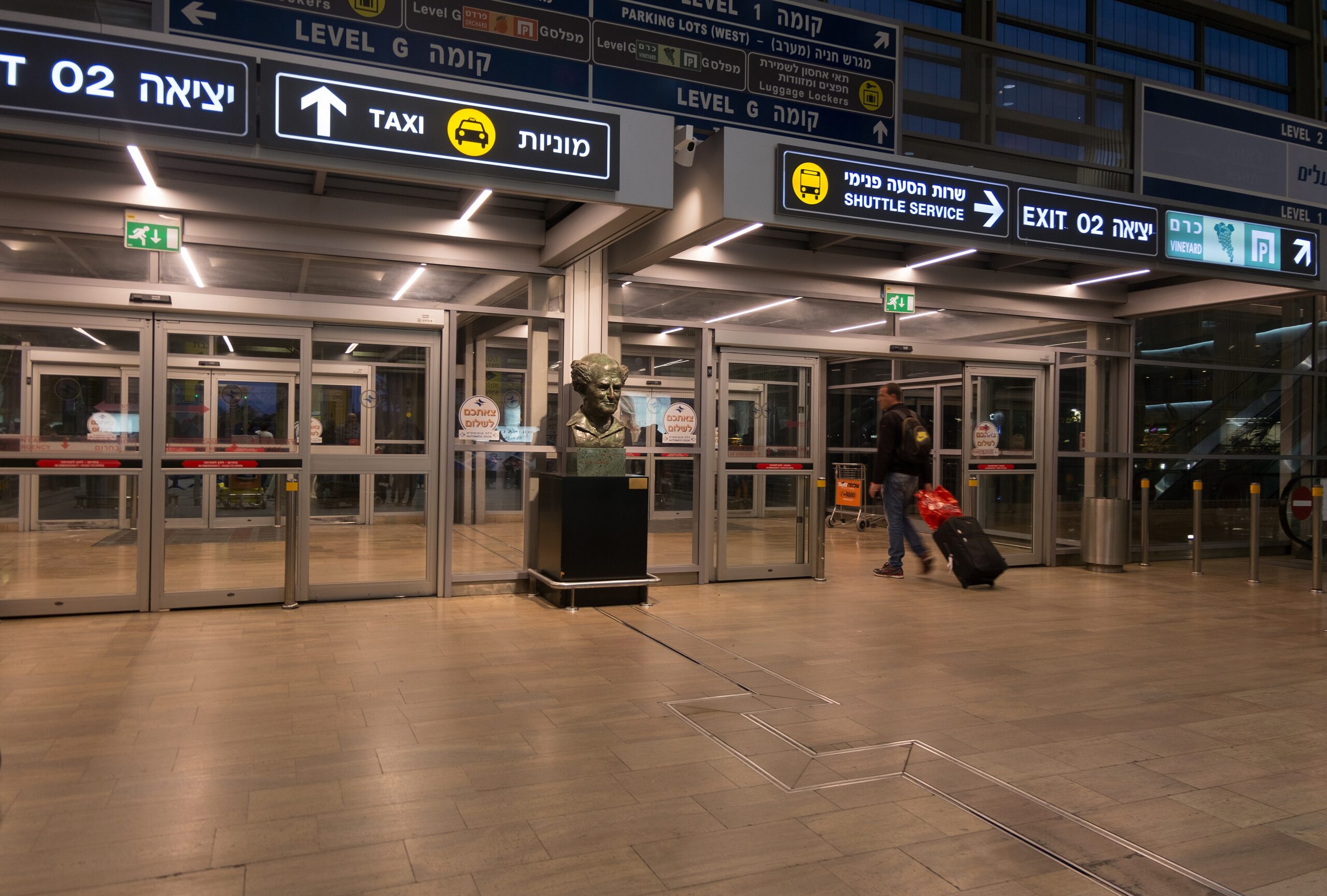 Image shows an almost empty well-lit entrance to Ben Gurion International Airport in Tel Aviv, Israel at night
