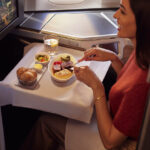 A British Airways Club World passenger enjoys a meal.