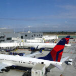 A view of the Los Angeles International Airport tarmac and the new Terminal from the Delta Sky Club Sky Deck in Terminal 3. A Delta Air Lines Boeing 737-900ER (Reg: N907DN MSN: 32010) is parked at gate 31 and waiting for departure to Nashville (KBNA). An Airbus A321 is behind the 737-900.