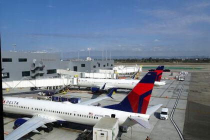 A view of the Los Angeles International Airport tarmac and the new Terminal from the Delta Sky Club Sky Deck in Terminal 3. A Delta Air Lines Boeing 737-900ER (Reg: N907DN MSN: 32010) is parked at gate 31 and waiting for departure to Nashville (KBNA). An Airbus A321 is behind the 737-900.
