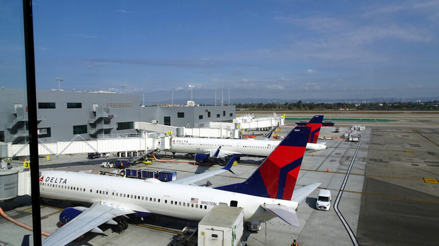 A view of the Los Angeles International Airport tarmac and the new Terminal from the Delta Sky Club Sky Deck in Terminal 3. A Delta Air Lines Boeing 737-900ER (Reg: N907DN MSN: 32010) is parked at gate 31 and waiting for departure to Nashville (KBNA). An Airbus A321 is behind the 737-900.