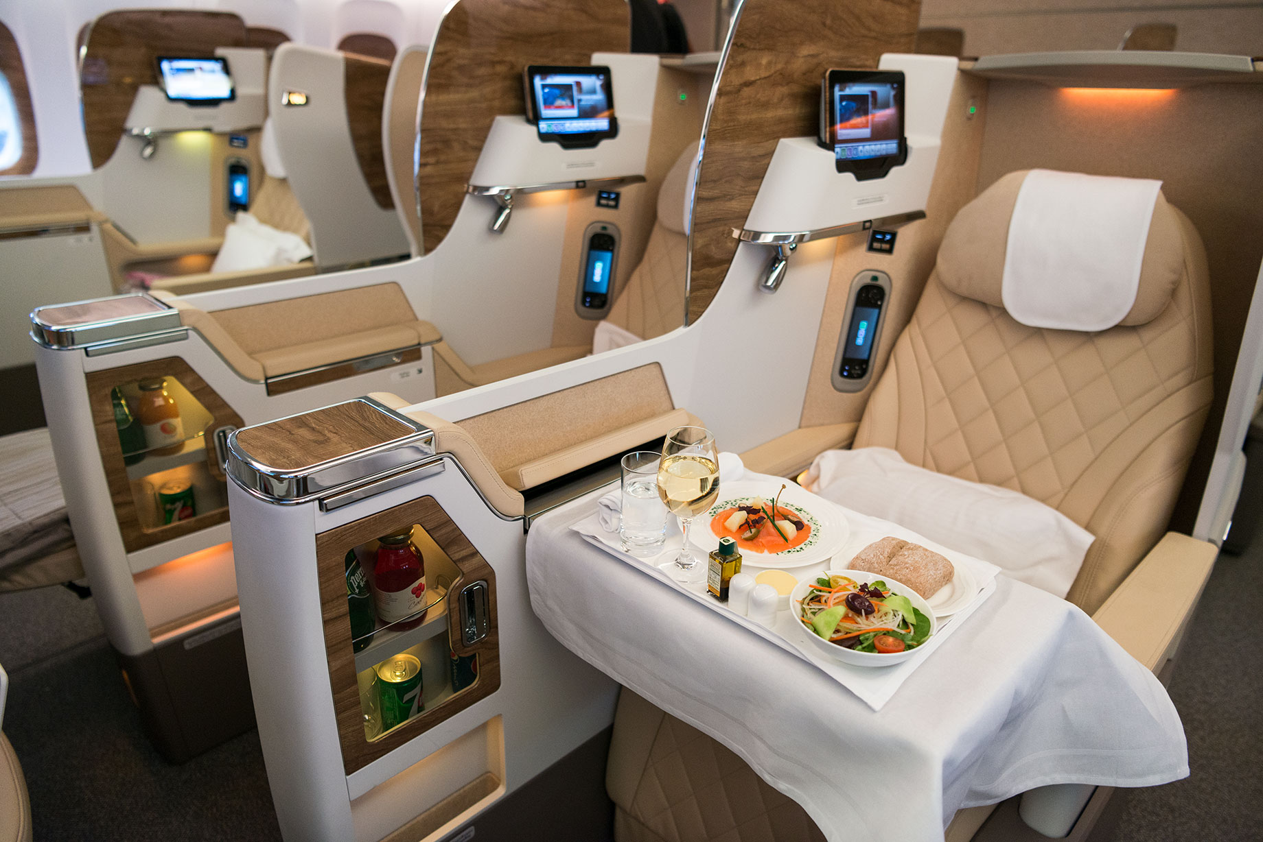 Emirates Boeing 777-200LR Business Class seat with food at table.