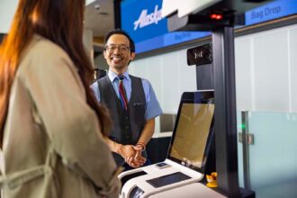 An Alaska Airlines staff member assisting a passenger
