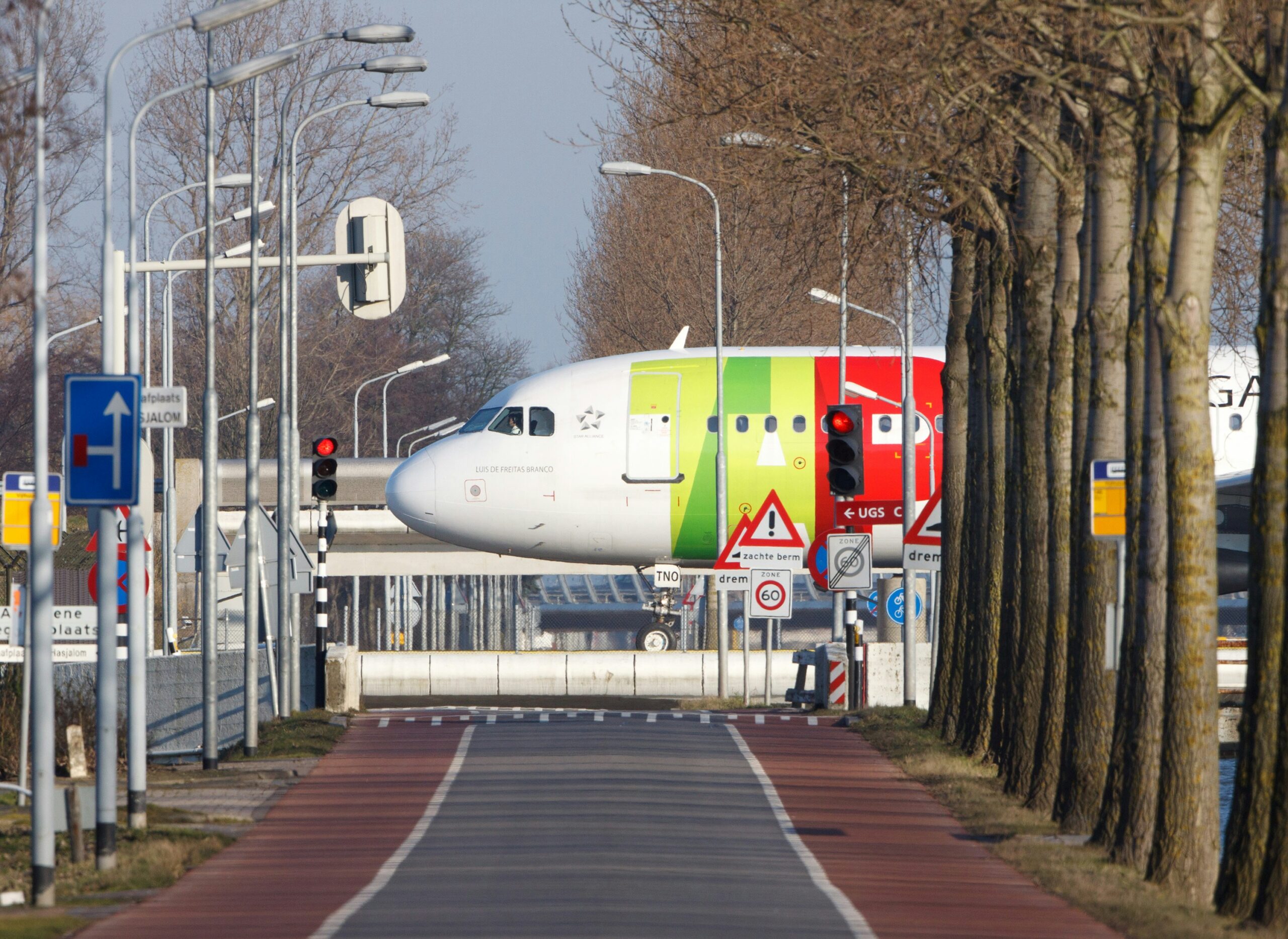 A large passenger jet positioned on a runway, preparing for takeoff or taxiing under a clear sky.