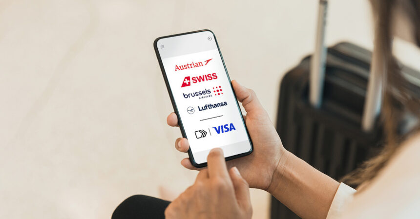 A person holding a smart phone. The screen showing the logos of Lufthansa Group airlines, including Lufthansa, SWISS, Austrian Airlines, and Brussels Airlines. © Lufthansa Group