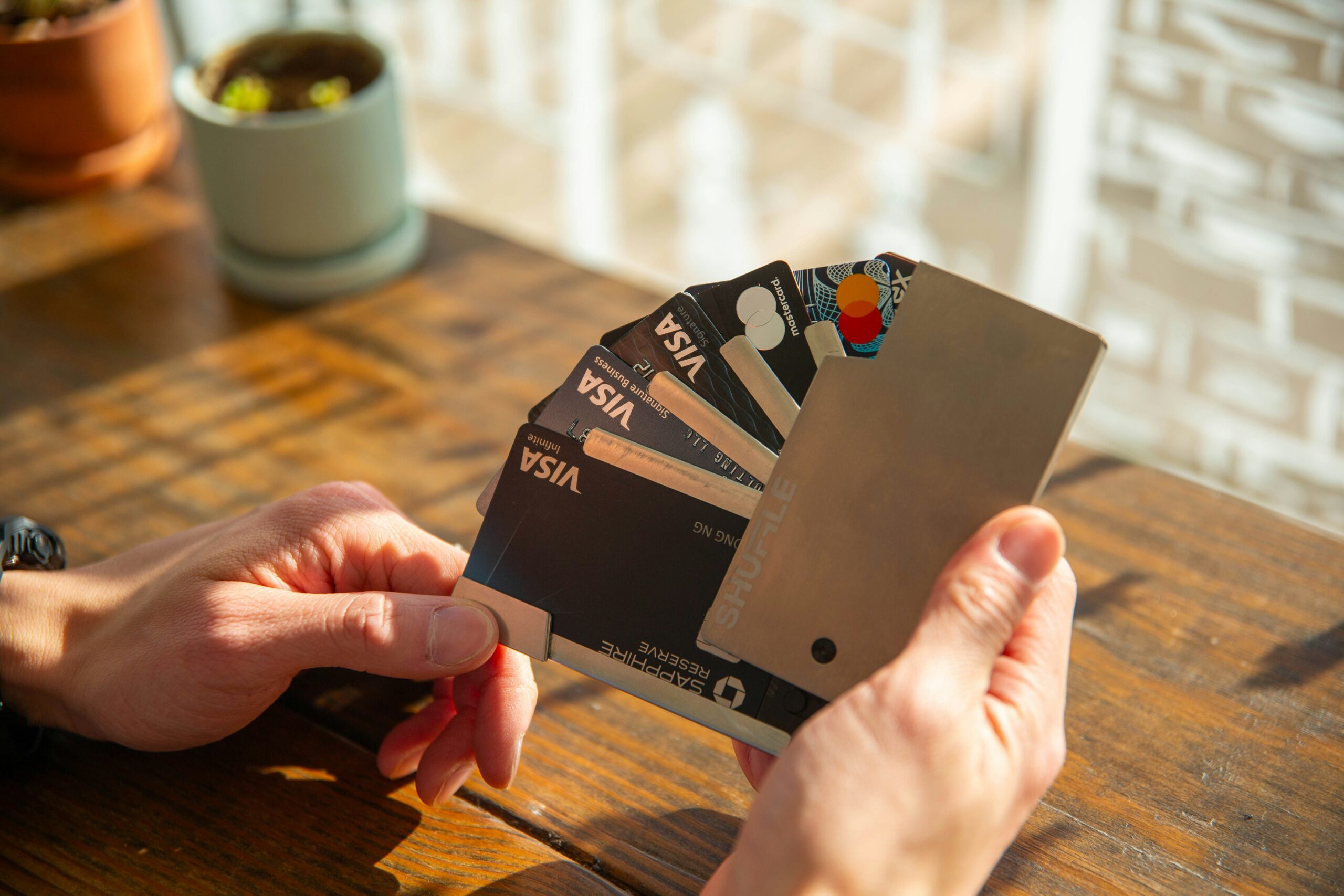 A close-up of a person presenting five Visa credit card, highlighting its luxurious look and feel.