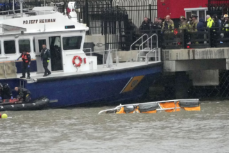 Firefighters and Police can be seen at the scene of the helicopter crash