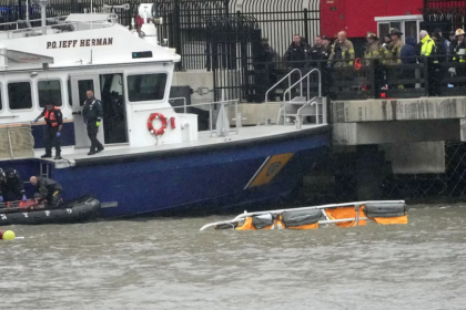 Firefighters and Police can be seen at the scene of the helicopter crash
