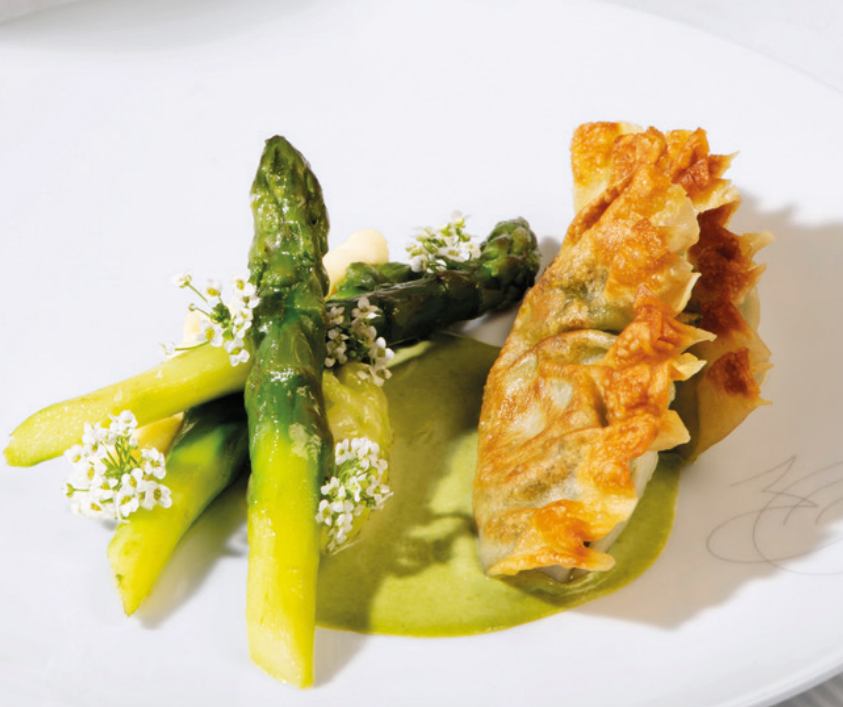 An Air France Michelin-starred dish, with asparagus, pastry and edible flowers.