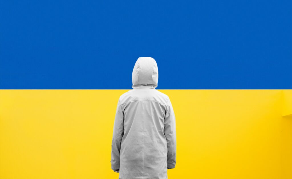 Ukrainian flag with person stood infront