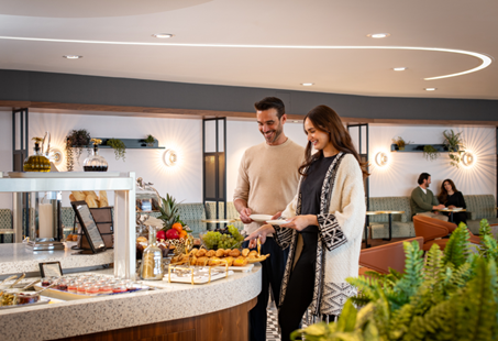 Two guests enjoy the international buffet in the lounge.