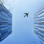 Aircraft between buildings.