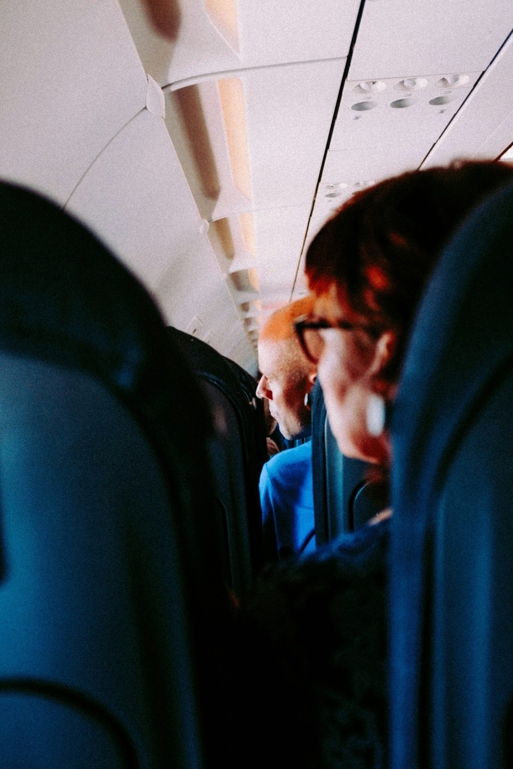 Passengers sitting looking out the window to depicy passenger disruption causing flight diversion from Manchester airport to Frankfurt 