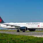 An Air Canada-operated Airbus A220 on an airport runway.